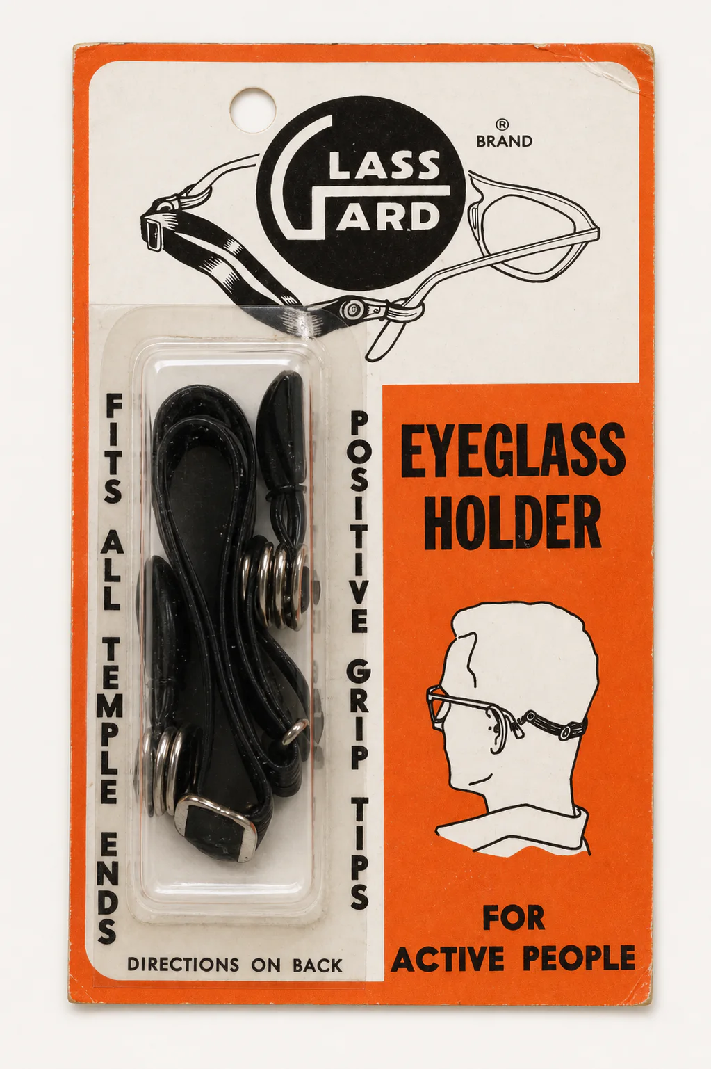 Restored archival photograph of the front of orange and white Glass-Gard eyeglass holder packaging