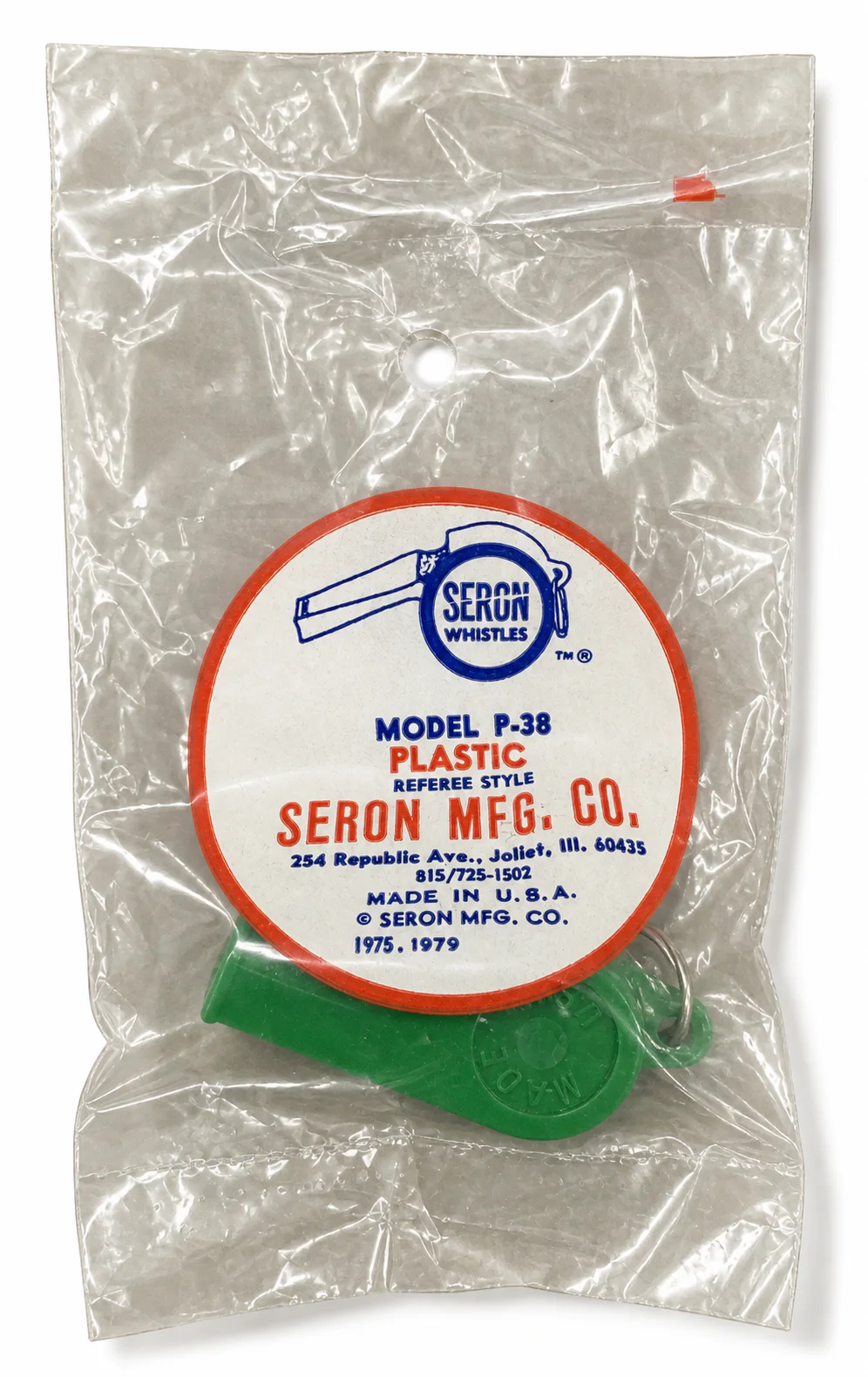 Original green Model P-38 whistle in labeled poly-bag packaging dated 1975 and 1979